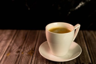 Koyu arkaplanda koyu aromalı bir fincan kahve. Beyaz bardakta kahve. Yüksek kalite fotoğraf