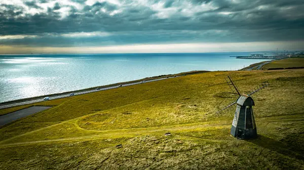 stock image Aerial view if an old windmill on the top of the cliff by the sea, Rottingdean, Brighton, East Sussex, UK