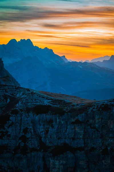The Tre Cime di Lavaredo also called the Drei Zinnen are three distinctive battlement-like peaks at sunset 