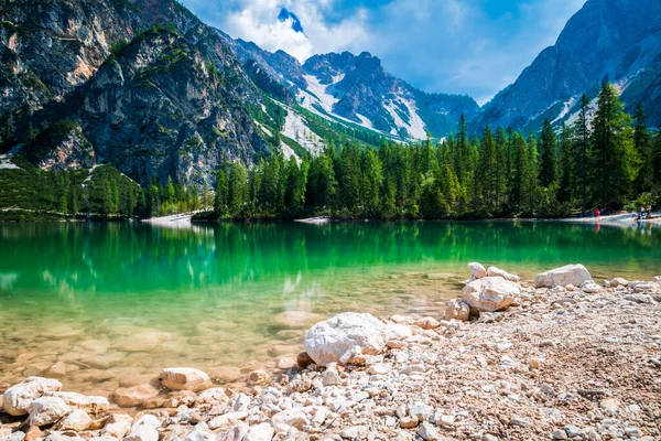 Dolomites. Braies lake and boats. Emerald colors on the water.