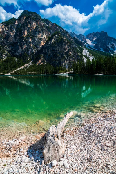 stock image Dolomites. Braies lake and boats. Emerald colors on the water.
