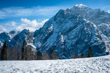 Scenic view of the mountains in Valbruna and Val Saisera at the end of winter. clipart