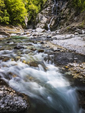 Waterfall and dam in the Julian Prealps.  Nature  clipart