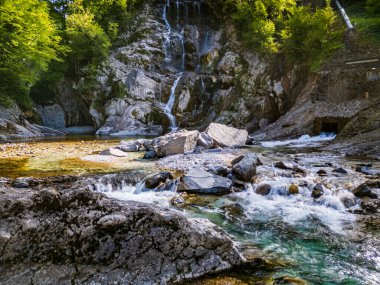 Waterfall and dam in the Julian Prealps.  Nature  clipart