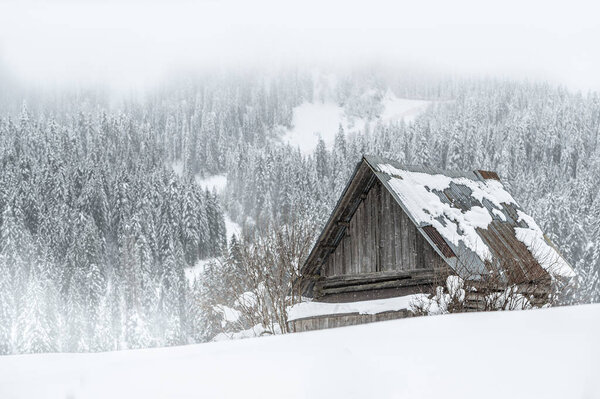 beautiful landscape with hut in winter mountains 