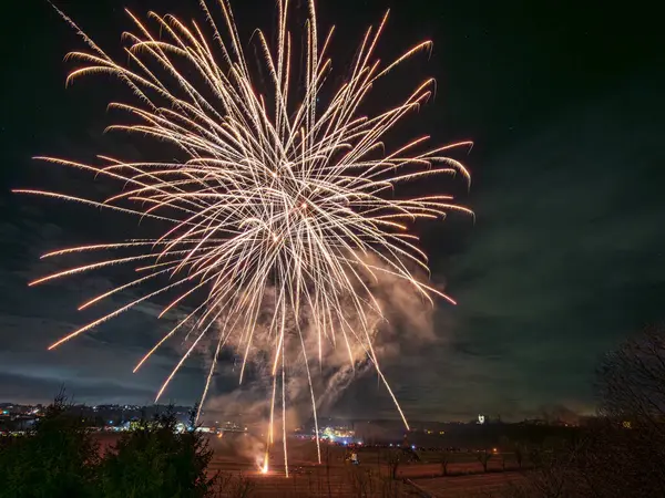 stock image Brilliant fireworks burst in an array of colors and illuminating the night sky 