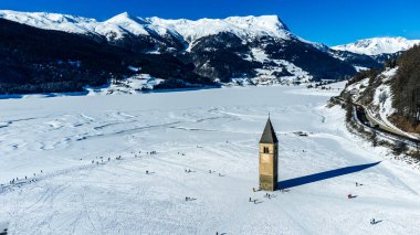 View of the ancient bell tower of Curon Venosta on Lake Resia clipart