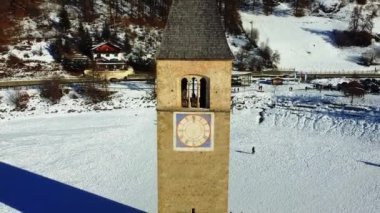 Resia Gölü 'nde kış ve eski Curon köyünün muhteşem ıssız çan kulesi Val Venosta.