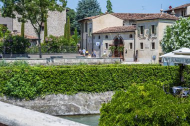 Summer on the Mincio river. Historic village of Borghetto sul Mincio clipart