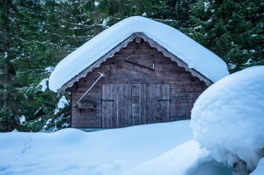 Tarvisio. Snowy houses in Riofreddo valley at  winter at the foot of the Julian Alps clipart