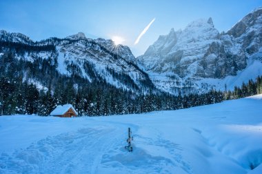 Tarvisio. Snowy houses in Riofreddo valley at  winter at the foot of the Julian Alps clipart