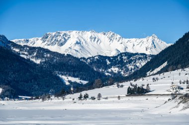 Resia Lake. Curon. The wonder of the Venosta Valley in winter. clipart