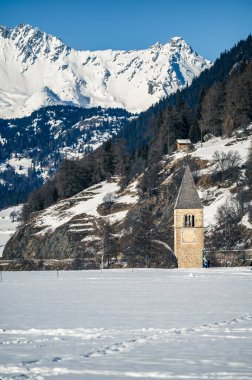 Resia Lake. Curon. The wonder of the Venosta Valley in winter. clipart