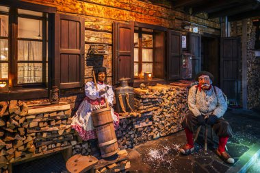 Ancient carnival celebration with people in wooden masks from Sauris. Magic of Carnia for the arrival of spring clipart