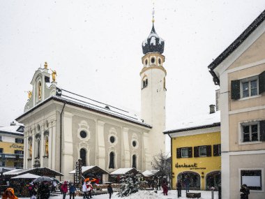 Tourists Walking at Christmas Markets in San Candido. Magical Val Pusteria Under the Snow. clipart