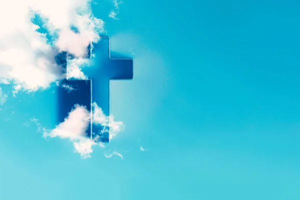 Ascension day concept. Christian Easter. Shining cross in clouds on blue sky. Copy space. Faith in Jesus Christ. Christianity. Church worship, salvation concept. Gate to heaven. Eternal life of soul.