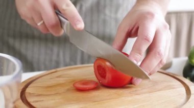 closeup man hands making salad adding vegetables to the bowl , healthy food