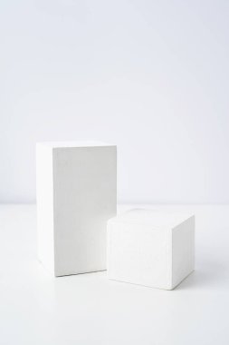 A minimalistic scene of a gypsum podium on white background. Round white catwalk for the presentation of products and cosmetics. Showcase with a stage for products, mockup design, seasonal