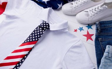 ABD Anma Günü, Başkanlar Günü, Gaziler Günü, İşçi Bayramı ya da 4 Temmuz kutlamaları. Logo için beyaz polo tişörtü, Amerikan bayrağı, ayakkabısı ve kotuyla beyaz ahşap arka planda üst görünüm
