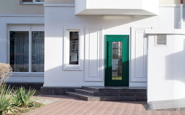 stock image establishment exterior with white walls and green door, mockup design, shadow overlay