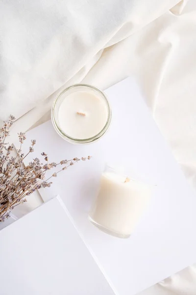 stock image Soy wax aroma candles in jar on bed with lavender flowers. Candle mockup design. Mockup soy wax candle in natural style.