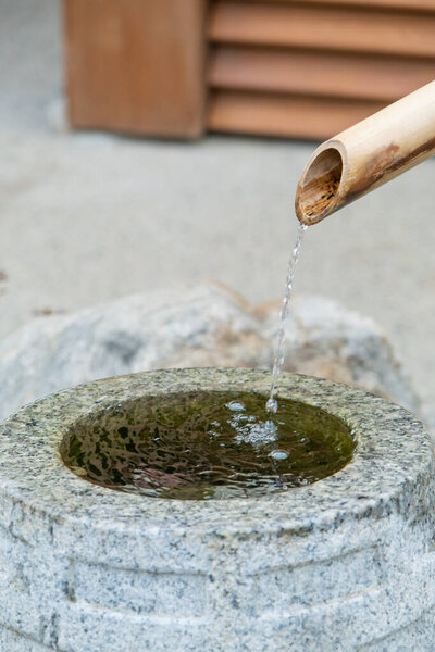 Water ladle and basin for cleansing at shrine in Kyoto, Japan