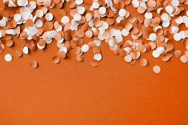 Color of the year 2024: Peach Fuzz. 4th of July American Independence Day, colorful circle shape confetti from shredded paper , decorations for fourth july with copy space