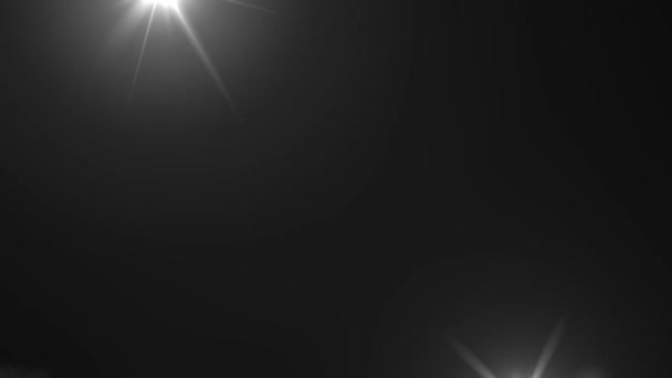黒い背景に対するレンズフレア効果 — ストック動画