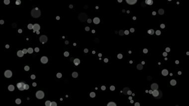 Siyah arkaplan üzerinde beyaz daireler bokeh parçacıkları soyut arkaplan döngüsü.