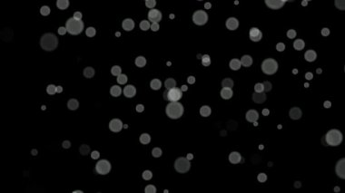 Siyah arkaplan üzerinde beyaz daireler bokeh parçacıkları soyut arkaplan döngüsü.