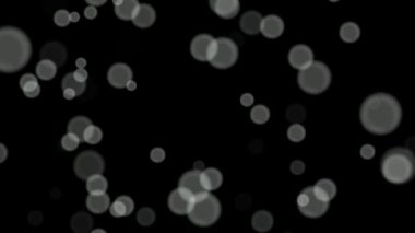 Siyah arkaplan üzerinde beyaz daireler bokeh parçacıkları soyut arkaplan döngüsü.