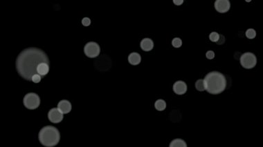 Siyah arkaplan üzerinde beyaz daireler bokeh parçacıkları soyut arkaplan döngüsü.
