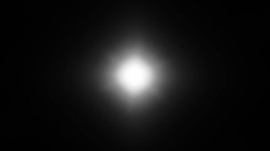 Siyah arkaplanda beyaz yıldız parlaması.