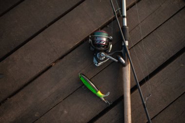 Flat lay shot of fishing rod and fishing bait clipart