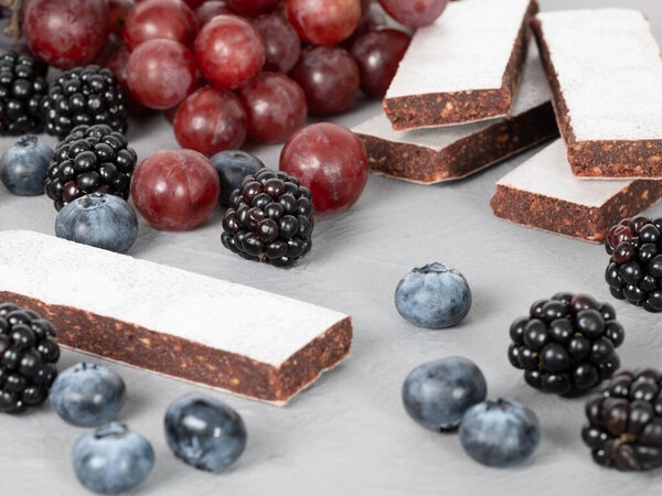 Dark fruit slices, decorated with blueberries, blackberries and red grapes