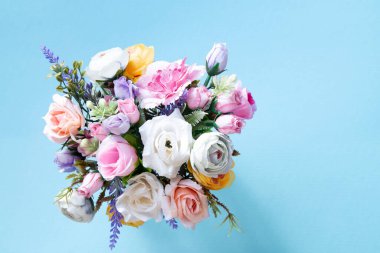 Flower bouquet on blue background with copy space