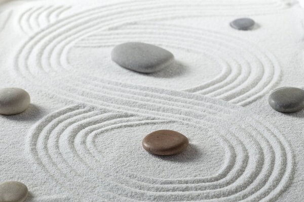 Zen garden with the stones and white sand