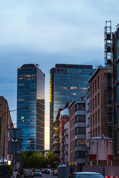 Street with houses and skyscrapers in Warsaw at sunset in spring