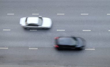 Motion blurred of automobile moving on road with speed on top view, traffic on city, background