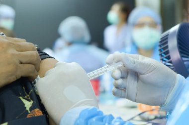 Bağışıklık enfeksiyonu, Corona virüsü ya da vücut, sağlık ve tıbbi bakımda covid-19 üretmek için insanların üst kollarına aşı yapan doktor elinin yakın ve seçici odak noktası