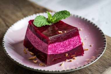 Layered Berry Jelly Dessert with Mint Leaf on Plate clipart