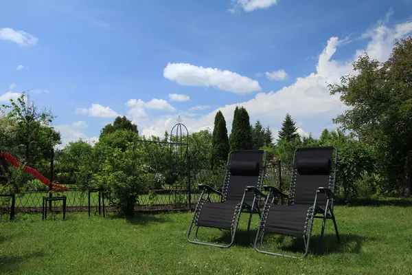 Reclining sun loungers in the garden on the green gras