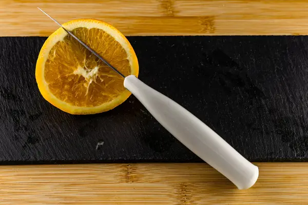 Yellow lemon cut in half on a stone slab, citrus fruits