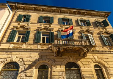 The historic office building in Rovinj with the national flag of Croatia displayed Istria  clipart