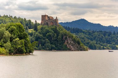 Restored ruins of the castle in Czorsztyn by the lake, tourist attraction, Instagram place in Poland clipart