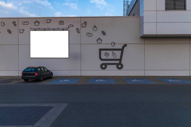 Shopping cart logo painted on the wall, parking spaces for disabled people next to the stor clipart