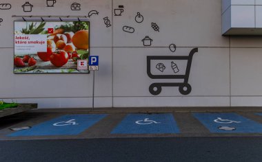 Shopping cart logo painted on the wall, parking spaces for disabled people next to the stor clipart