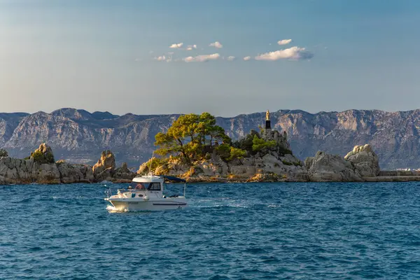 stock image Port in Trpanj, Peljesac Peninsula in Croatia, view of the statue of the Virgin Mary, rough Adriatic sea