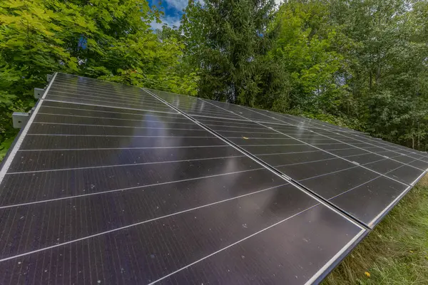 stock image Photovoltaic panels installed on a green meadow, cheap electricity for the household