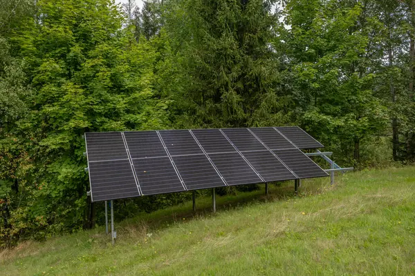 Stock image Photovoltaic panels installed on a green meadow, cheap electricity for the household